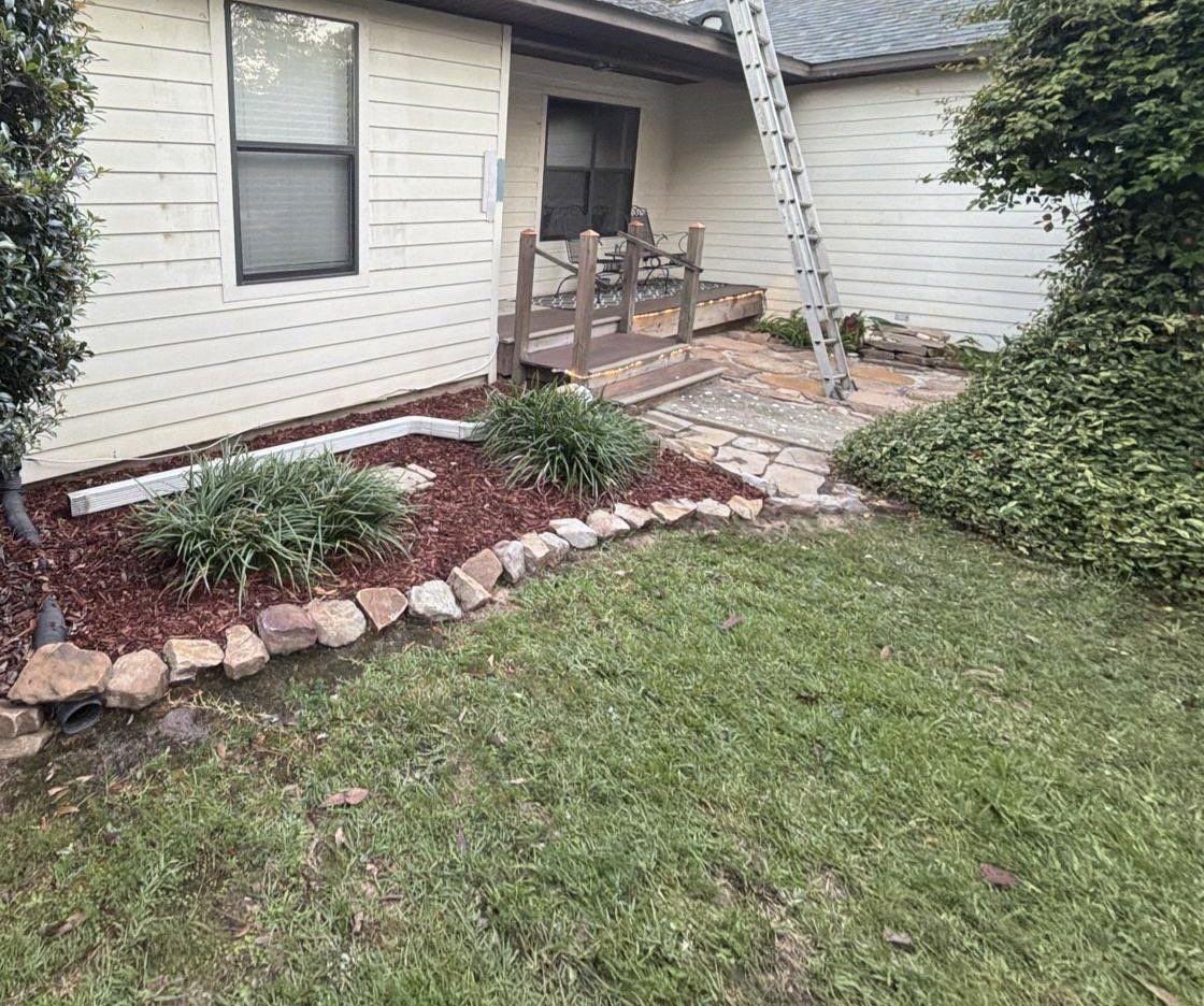 Finished roof and cleaned-up flower bed at a Lillian home